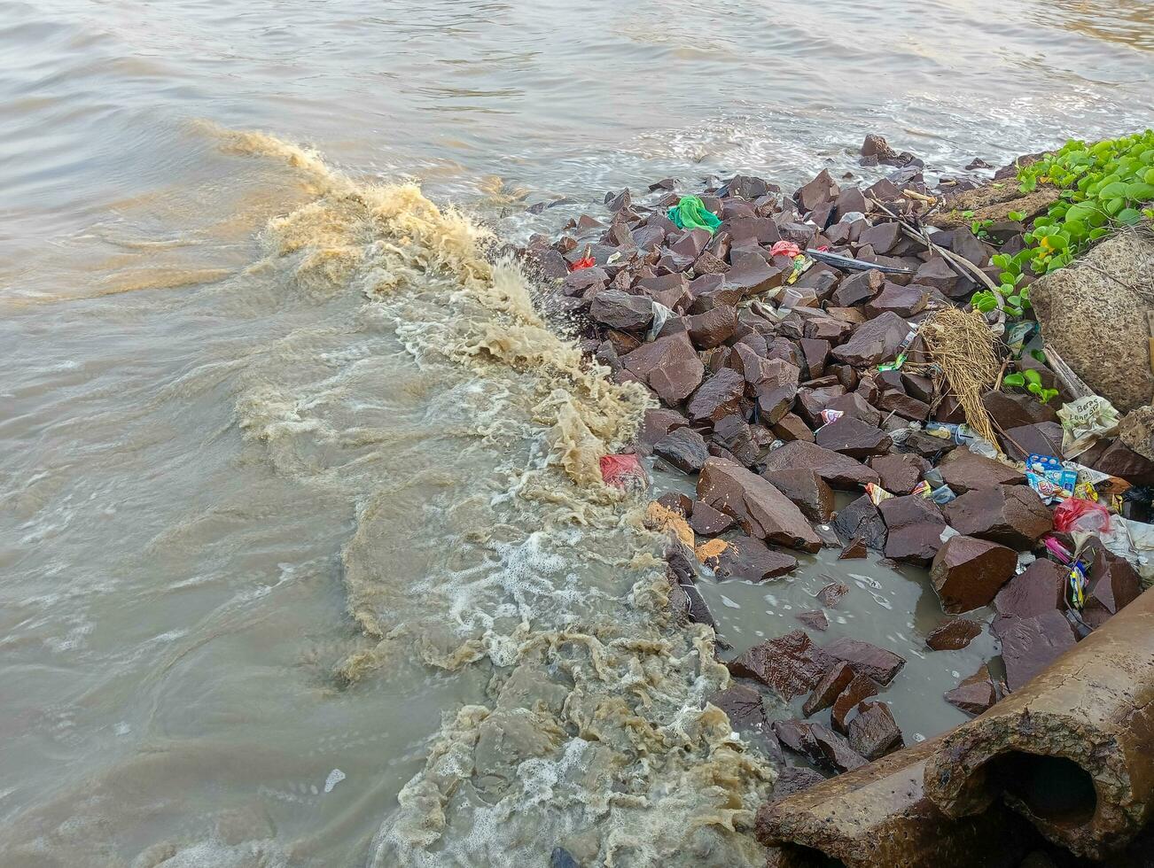 a brown river with rocks and water photo