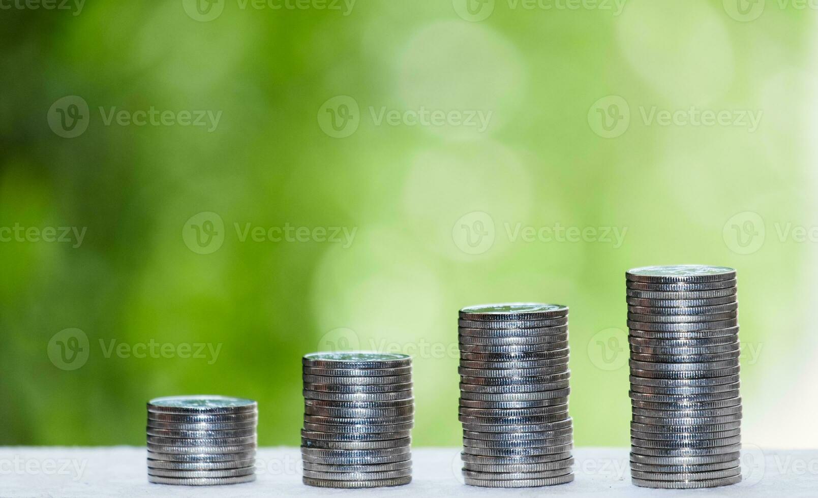 Business Finance and Money concept, Money coin stack growing graph with green tree bokeh background,investment concept photo