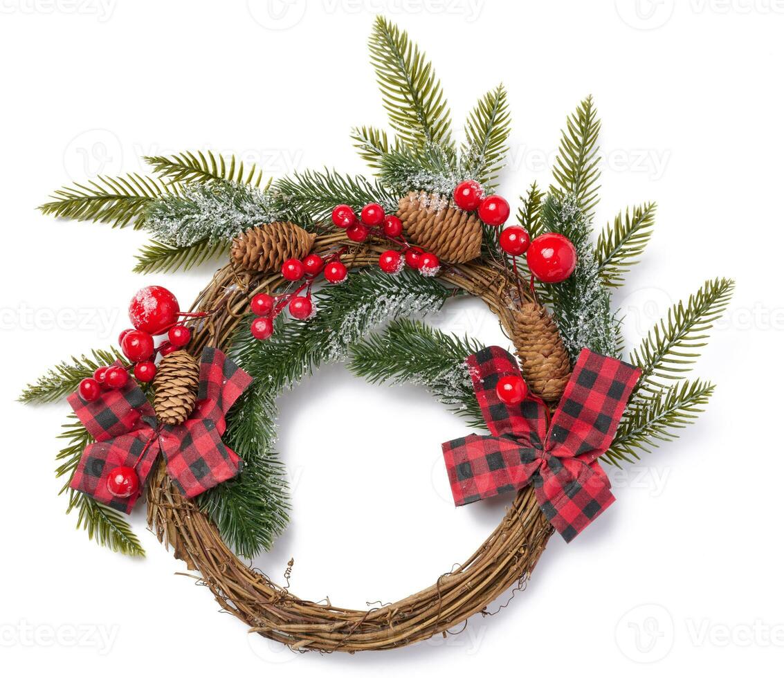 Christmas wreath made of spruce branches, ribbon and red berries photo