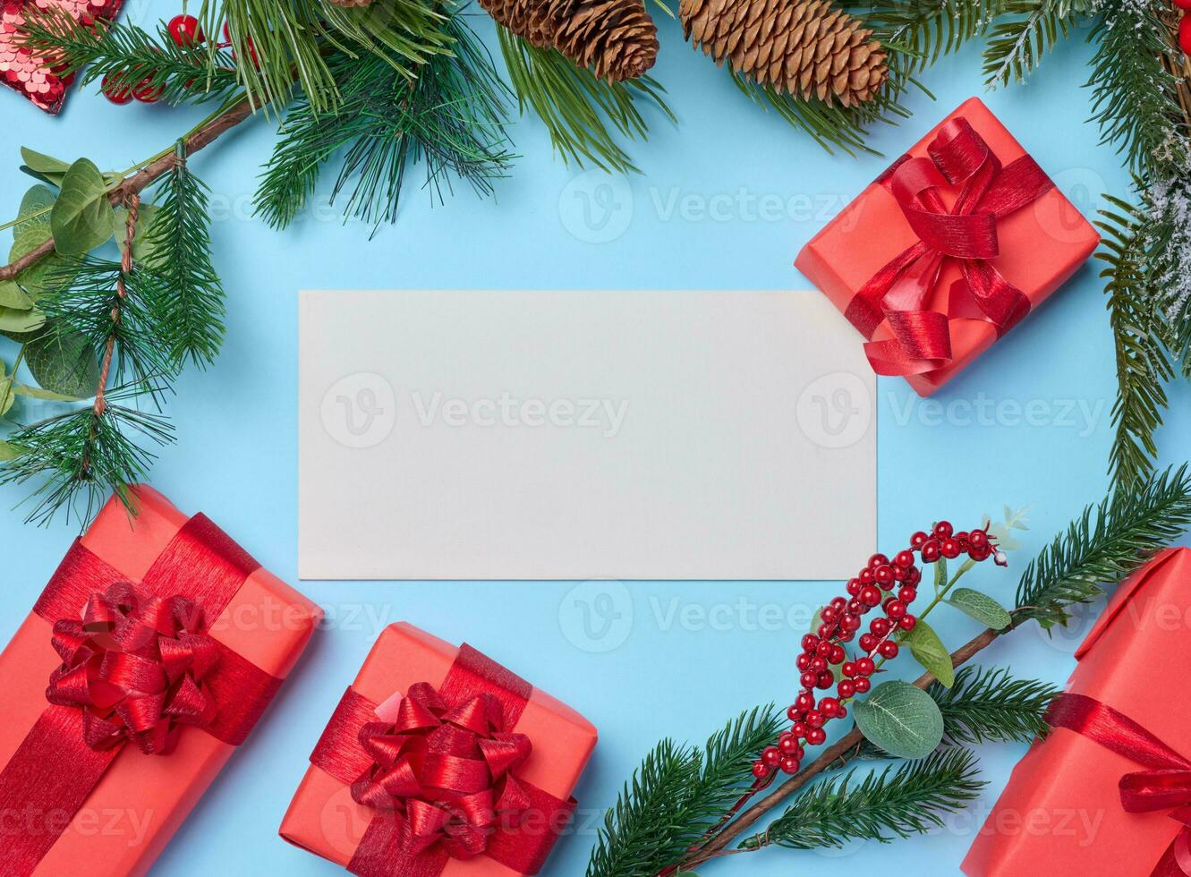 Christmas decor, gifts wrapped in red paper and a letter on a blue background, top view photo