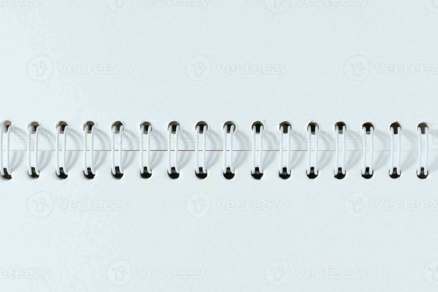 Open spiral notepad with blank white sheets photo
