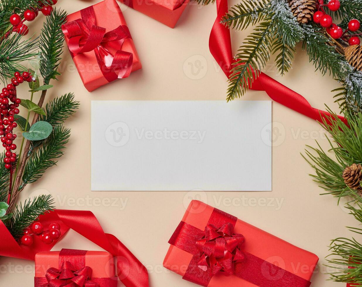 Christmas decor, gifts wrapped in red paper and a letter on a beige background photo