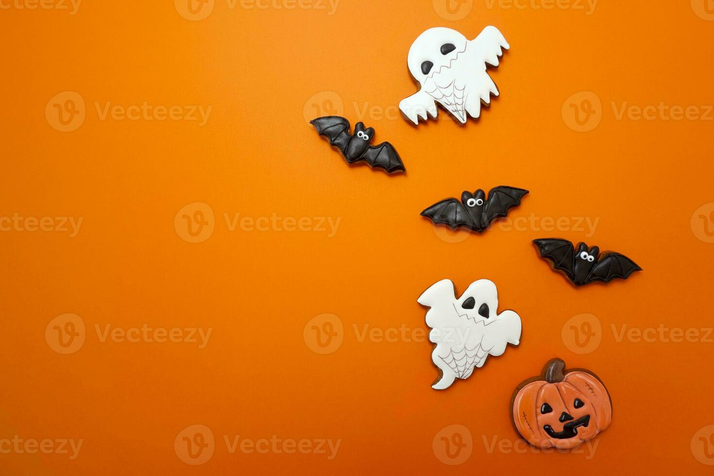 Gingerbread cookies for Halloween celebration are on an orange background photo