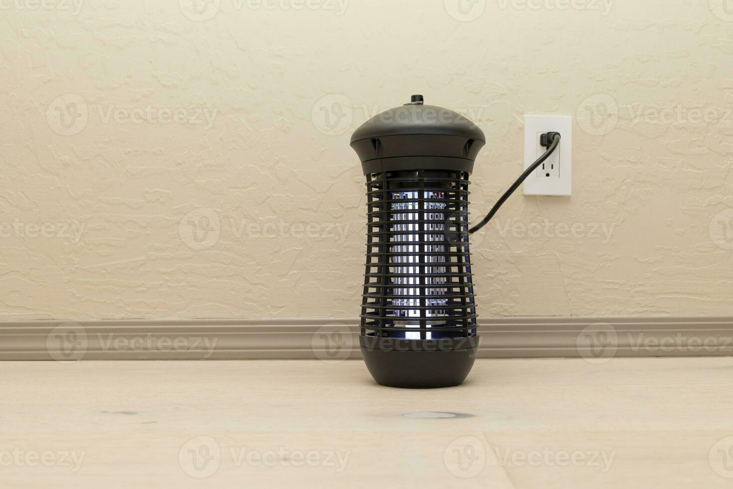 Electric Hanging Bug Killer Lamp . Mosquito and Insect Zapper With Blue Purple Lights .on Wooden Floor in Room. Fly Trap for Outdoor and Indoor. Copy Space For Text. Horizontal Plane photo