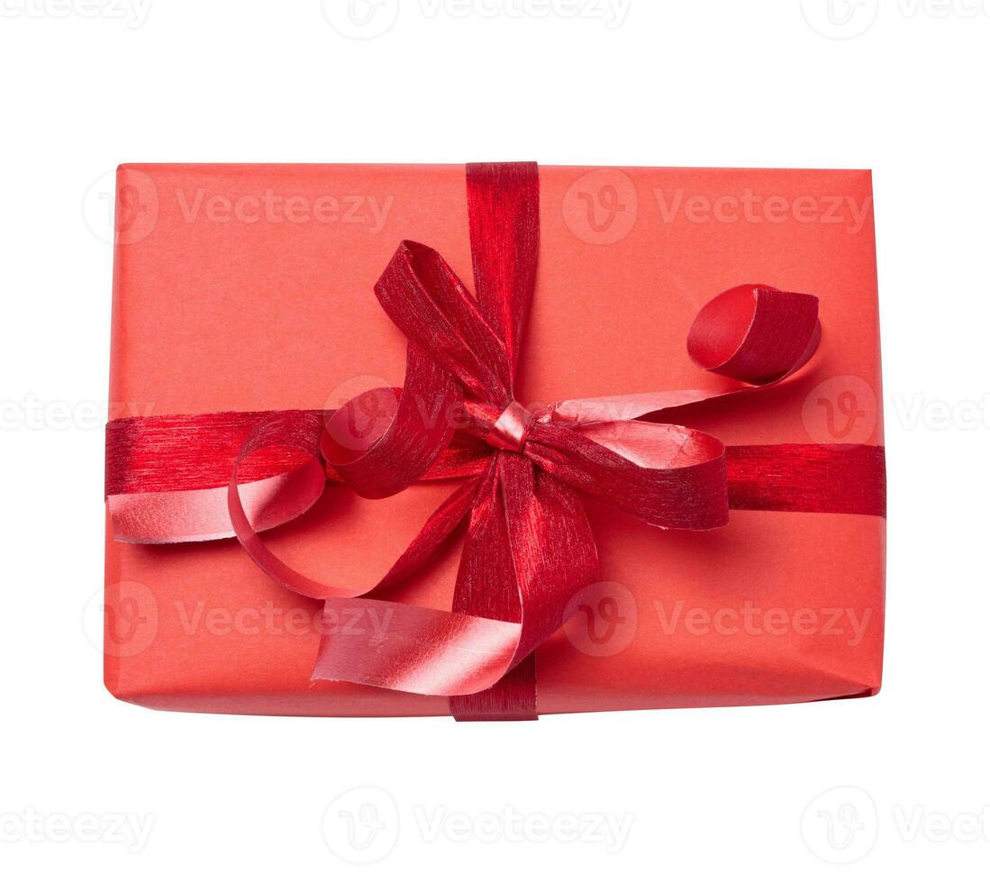 The box is wrapped in red gift wrapping and red ribbon on a white isolated background photo