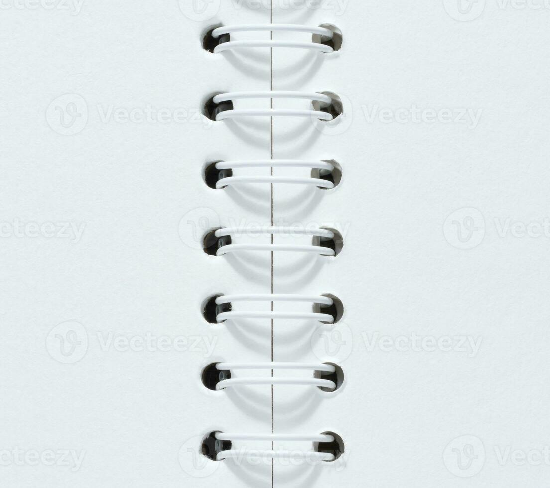Open spiral notepad with blank white sheets photo