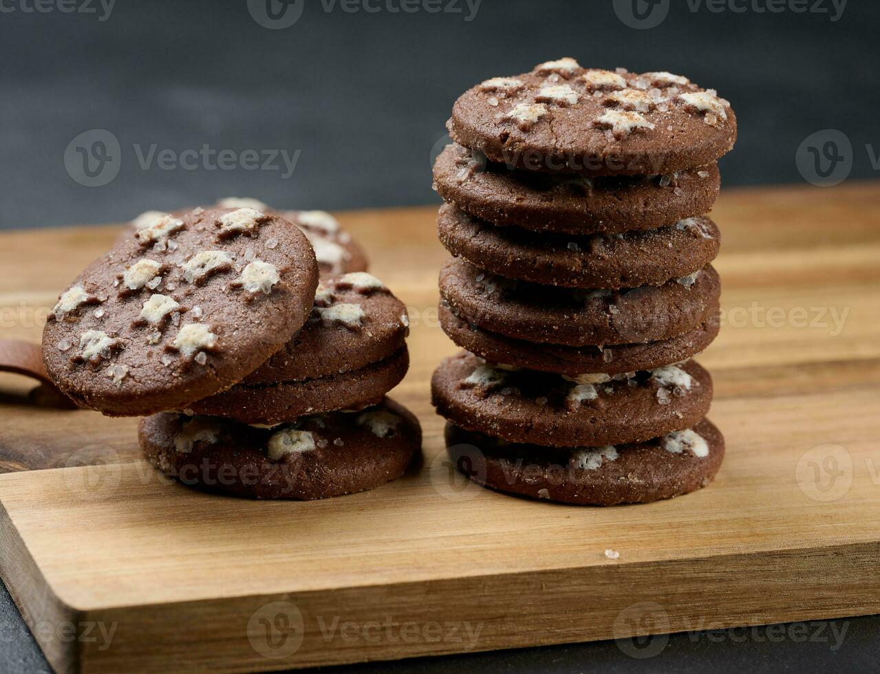 Stack of round chocolate cookies on a black background photo