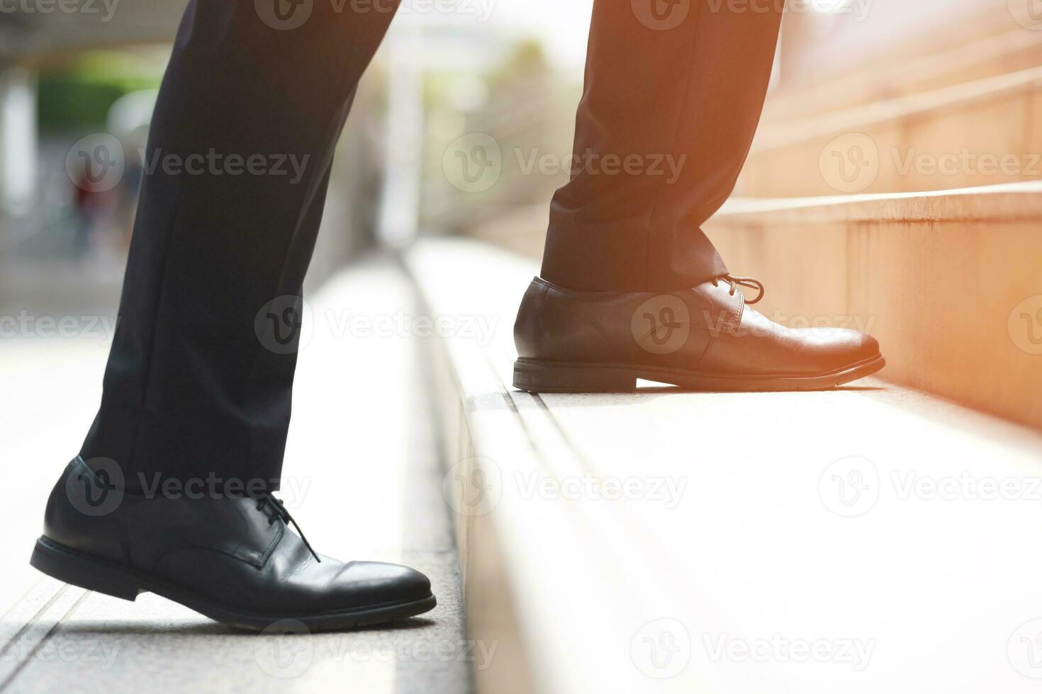 modern businessman working  close-up legs walking up the stairs in modern city. in rush hour to work in office a hurry. During the first morning of work. stairway. soft focus. photo