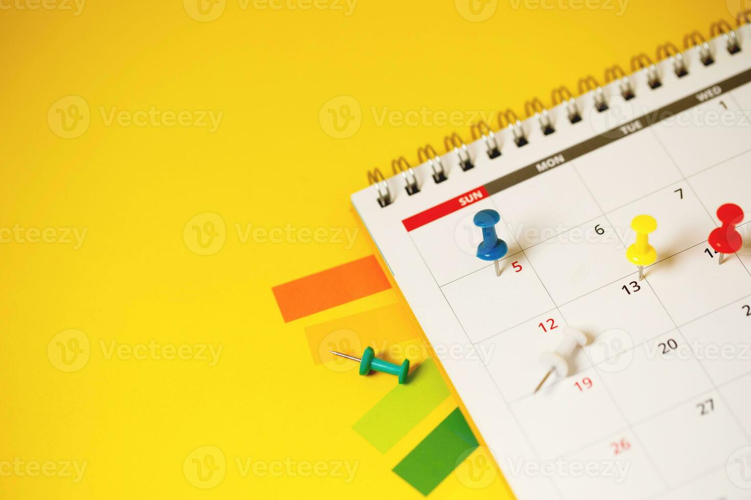 calendar month schedule to make appointment meeting or manage timetable each day lay and pen on yellow background for planning work and travel concept. photo
