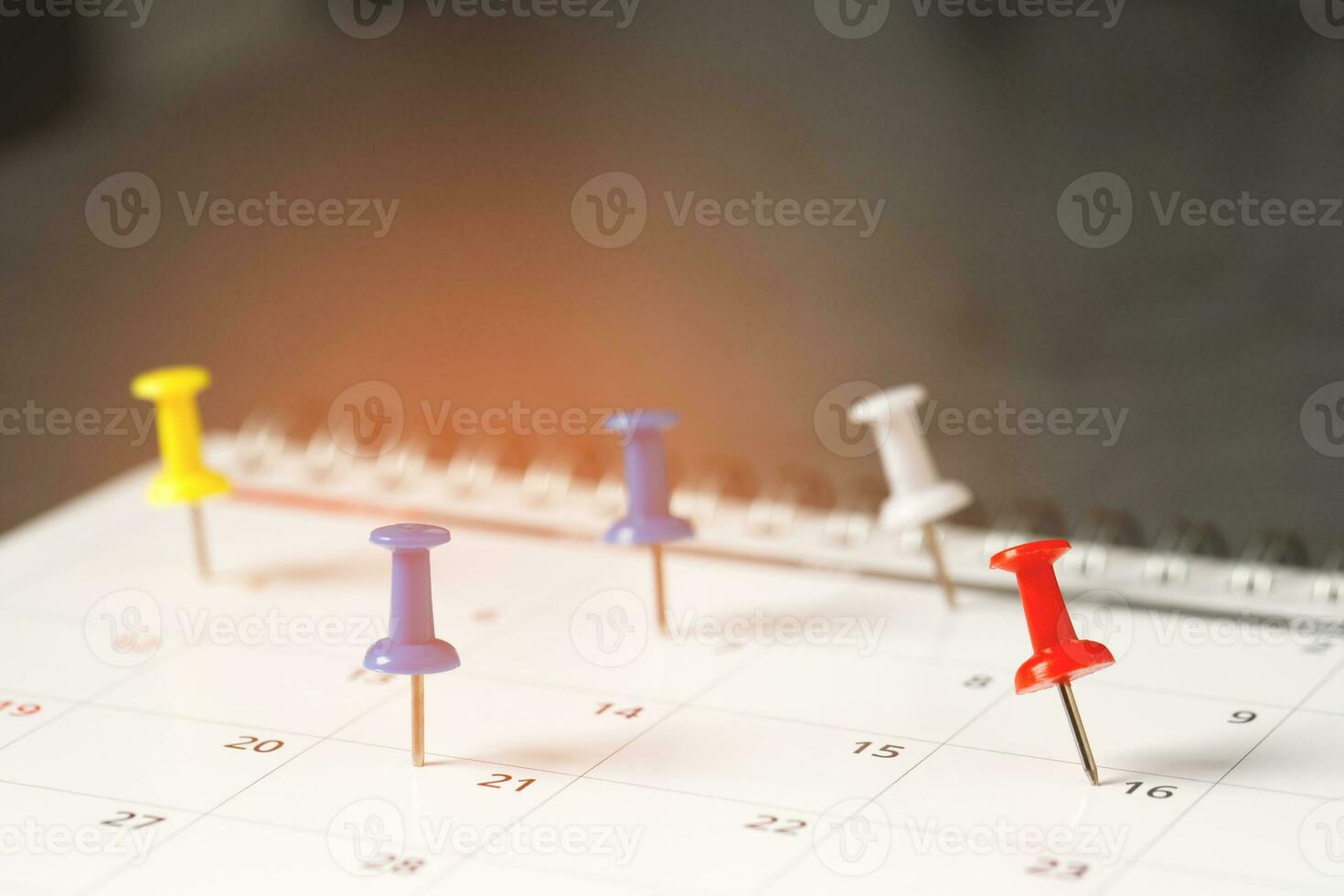 mark the event day with a pin. Thumbtack in calendar concept for busy timeline organize schedule,appointment meeting reminder. planning business meeting or travel holiday planning concept. soft focus photo
