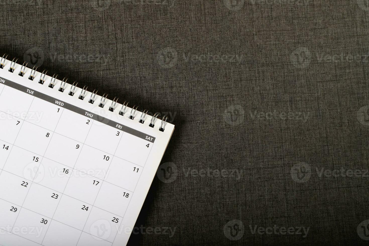 close up top view calendar month schedule to make appointment meeting or manage timetable each day lay on wooden background for planning work and travel concept. banner copy space photo