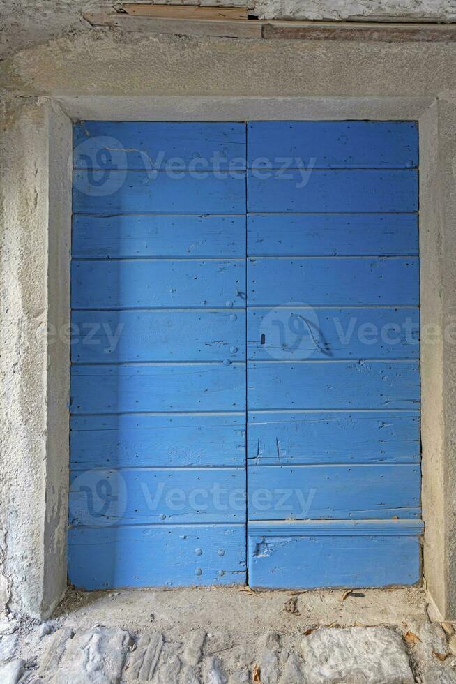 Image of a blue entrance door to a residential building with an antique facade photo