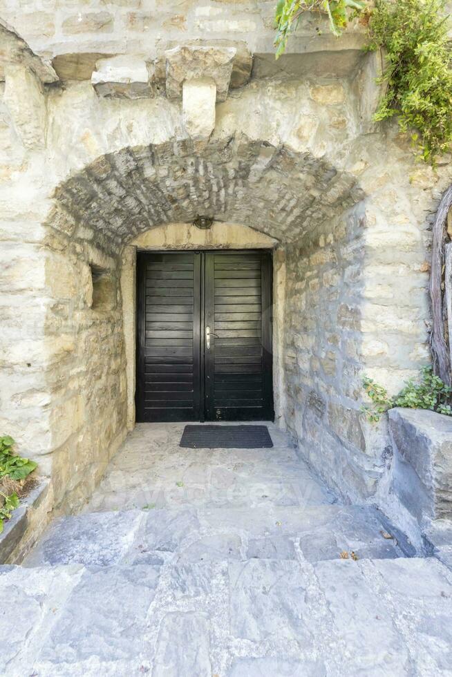 Image of a red entrance door to a residential building with an antique facade photo