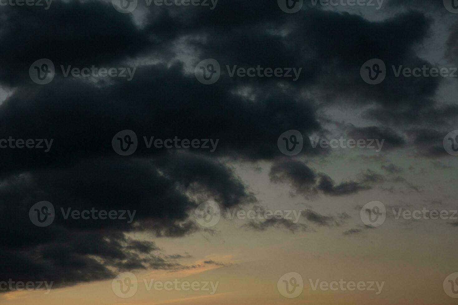 Stormy sky with dark clouds. Natural background. Sky background. Cloudscape, Colored Sunset. photo
