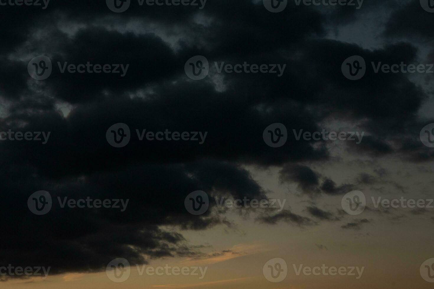 Stormy sky with dark clouds. Natural background. Sky background. Cloudscape, Colored Sunset. photo
