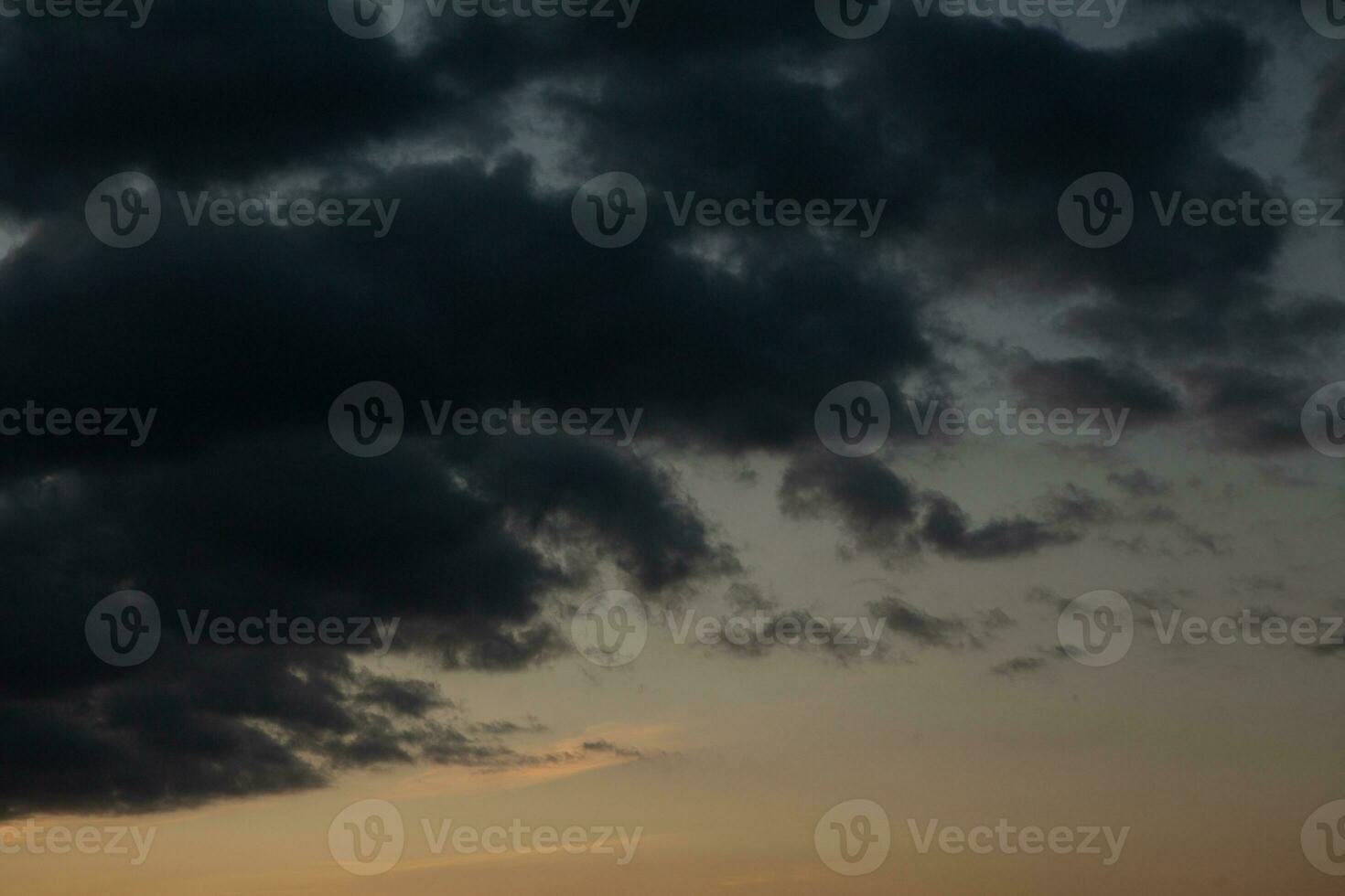 Stormy sky with dark clouds. Natural background. Sky background. Cloudscape, Colored Sunset. photo