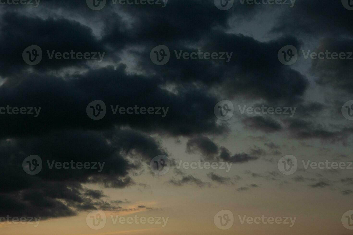 Stormy sky with dark clouds. Natural background. Sky background. Cloudscape, Colored Sunset. photo