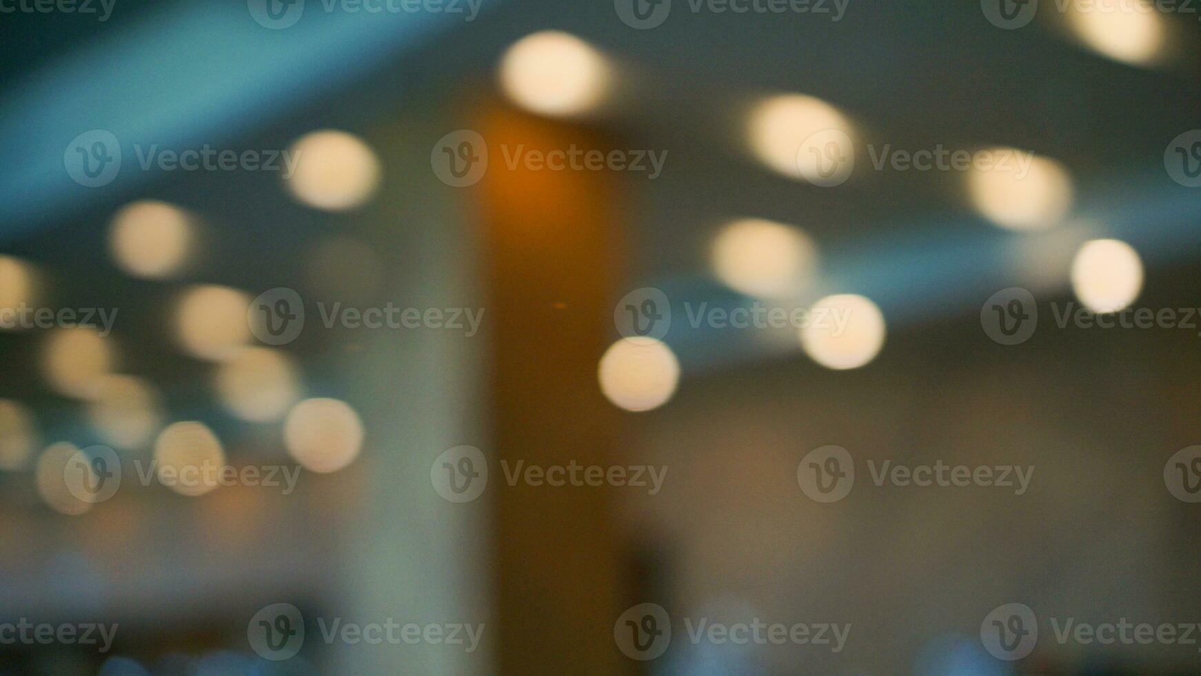 Blur abstract background of colorful bokeh circle light at night. Defocus gold light. Warm light with a beautiful pattern of round bokeh. Light in the room at night. Orange flare night wallpaper photo
