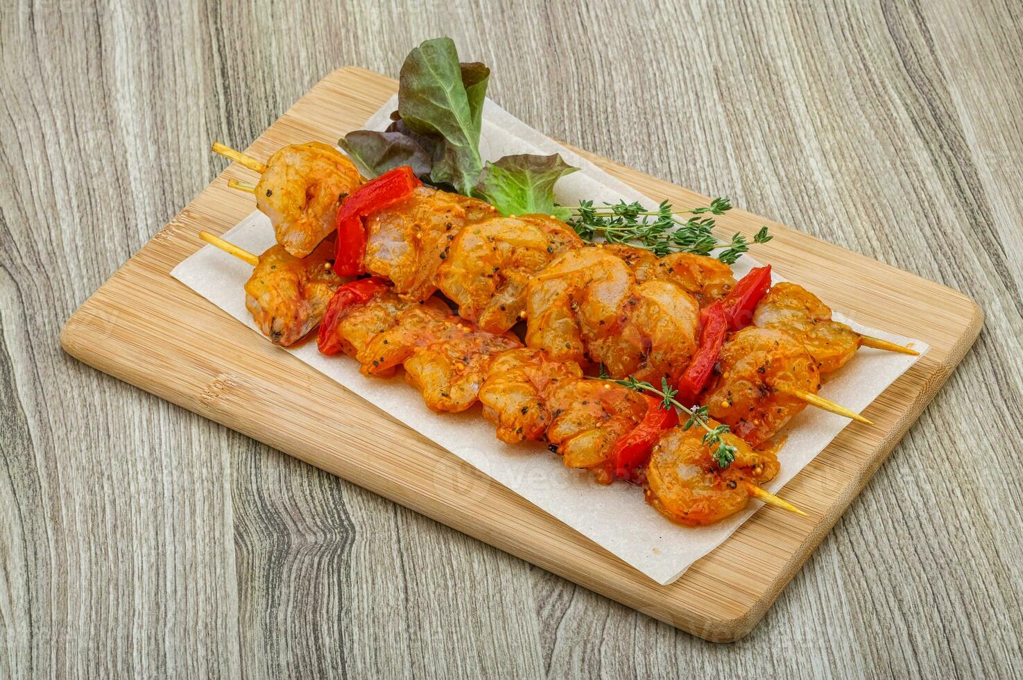 Raw tiger shrimps skewer photo