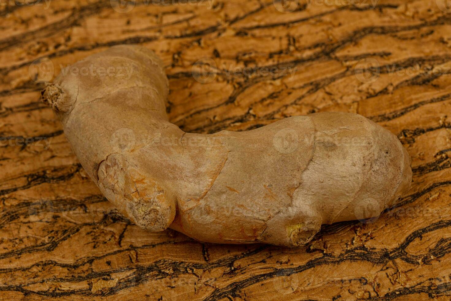 Ginger root over the wooden photo