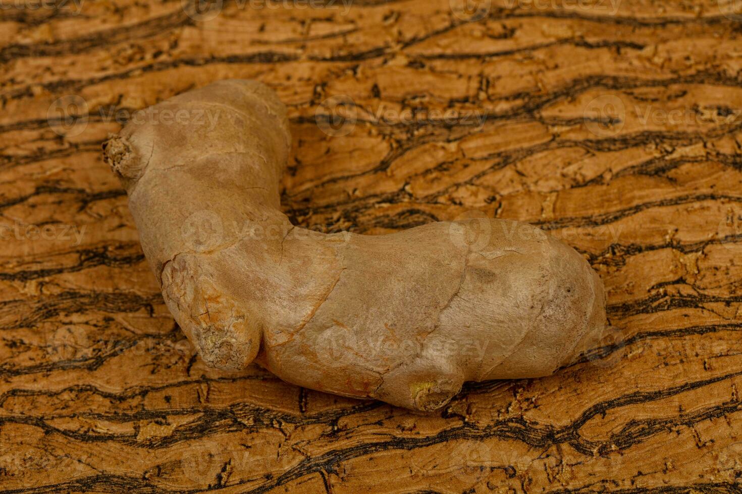 Ginger root over the wooden photo