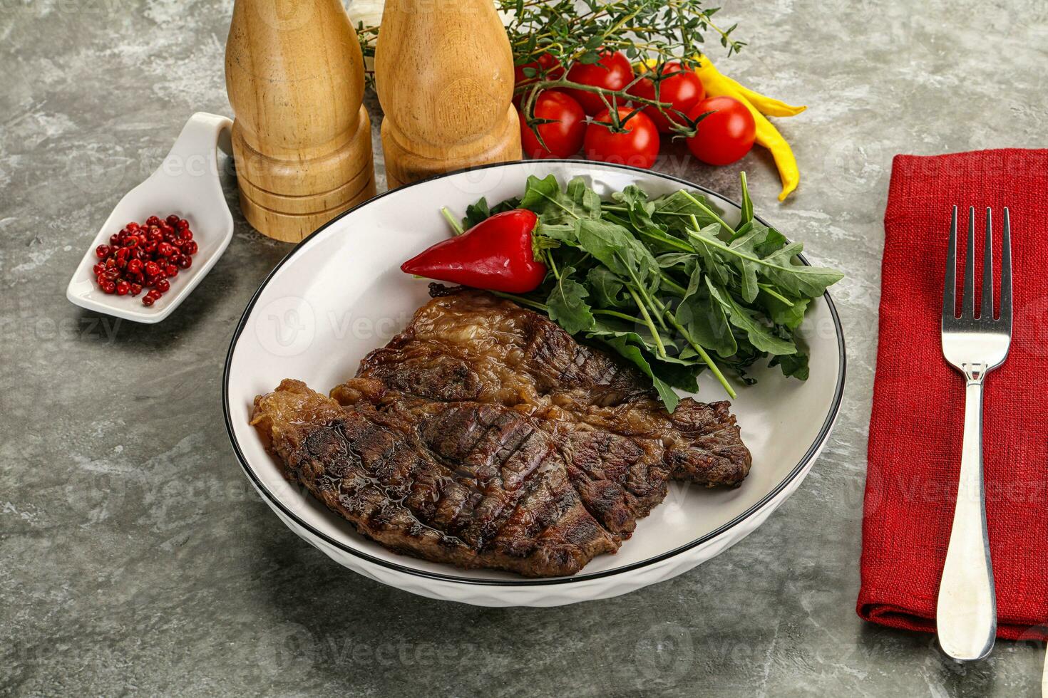 Grilled chuck roll steak with arugula photo