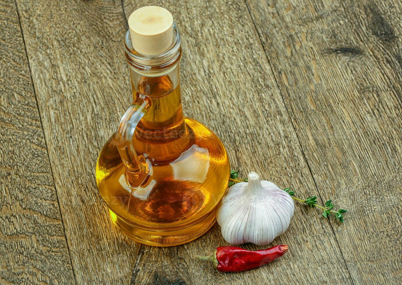 Sunflower oil on wooden background photo