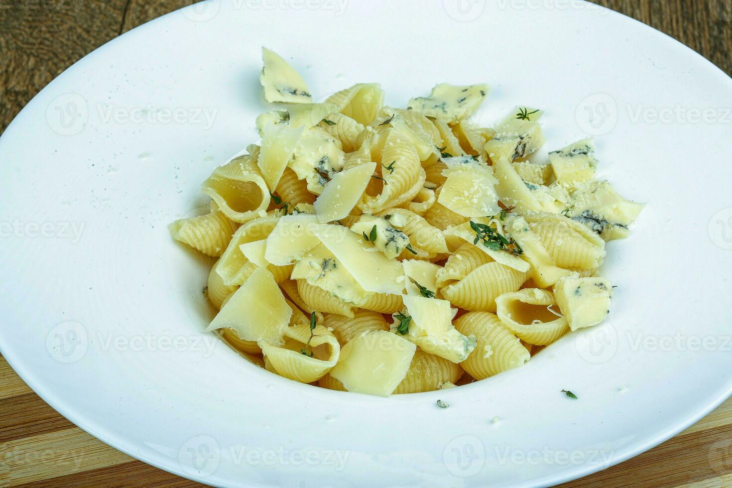 Cheese pasta on wooden background photo