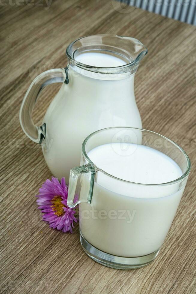 Milk on wooden background photo