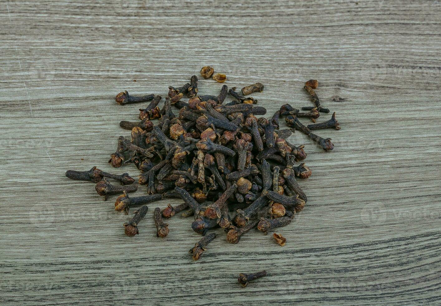 Cloves seeds on wooden background photo