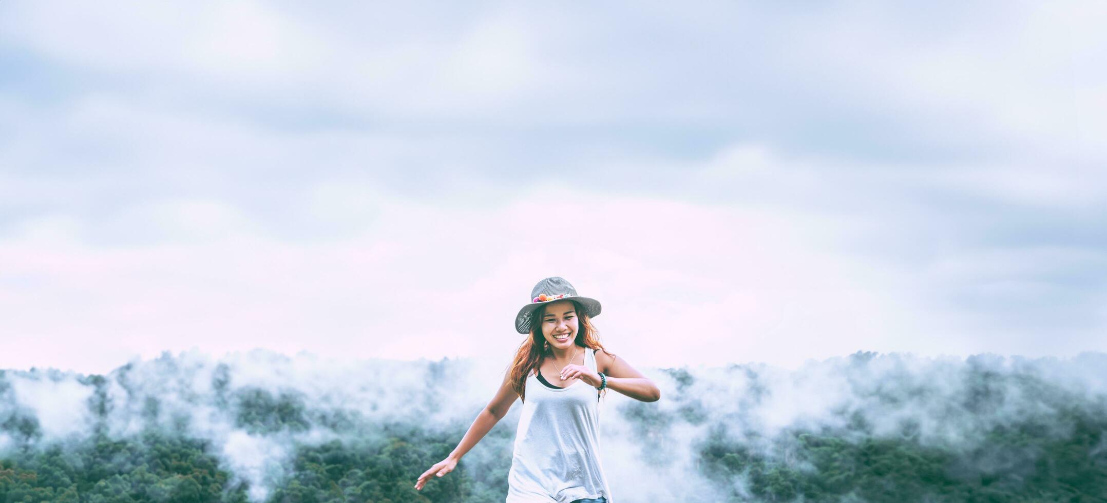 Asian women travel relax in the holiday. Wild nature wood on the mountain. photo