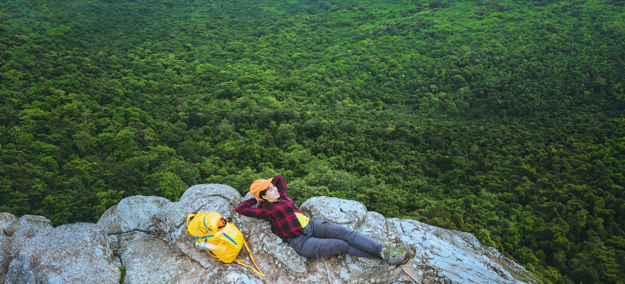 woman asians travel relax in the holiday. View mountain nature on the cliffs. photo