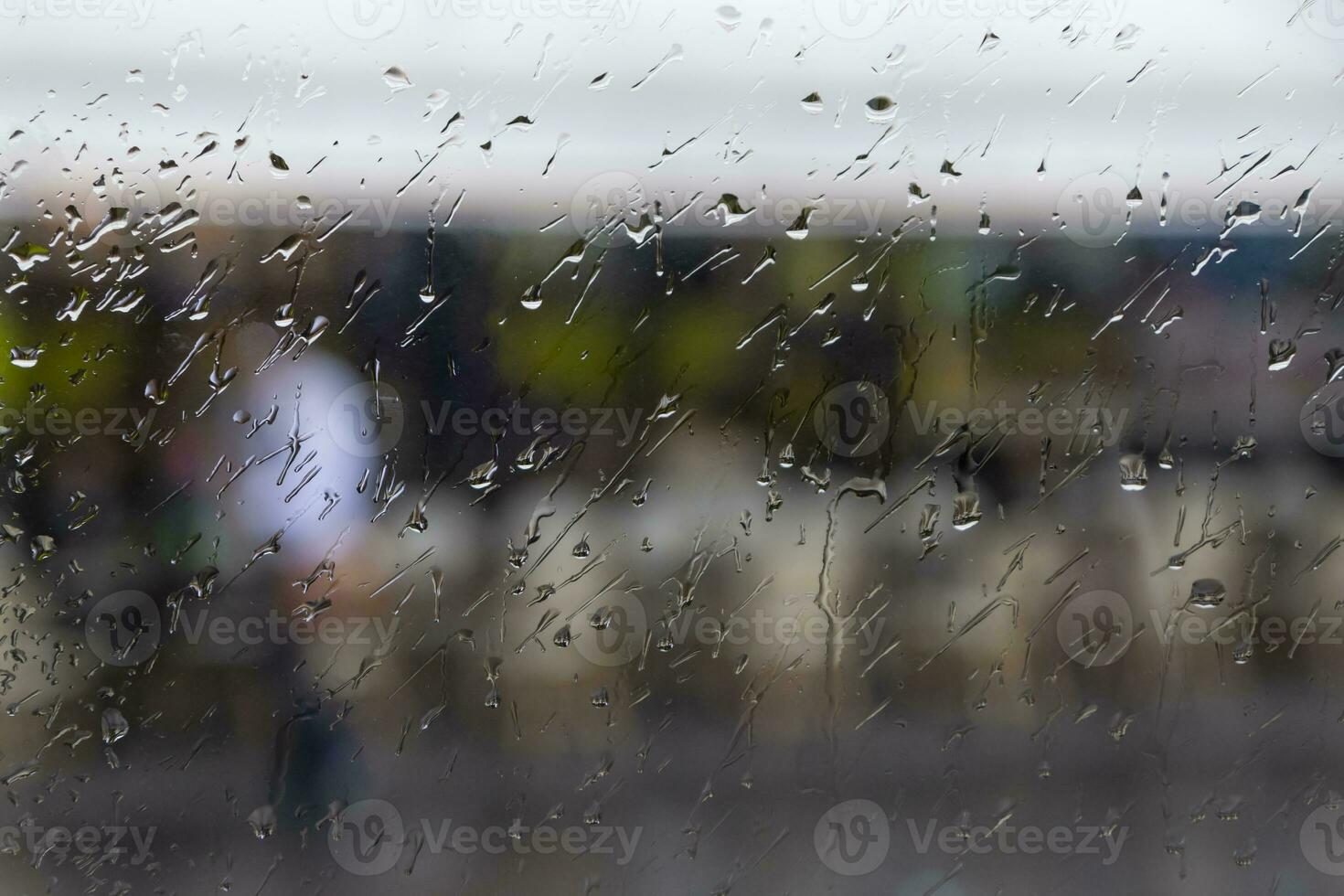 view on street of Paris through wet window of car photo