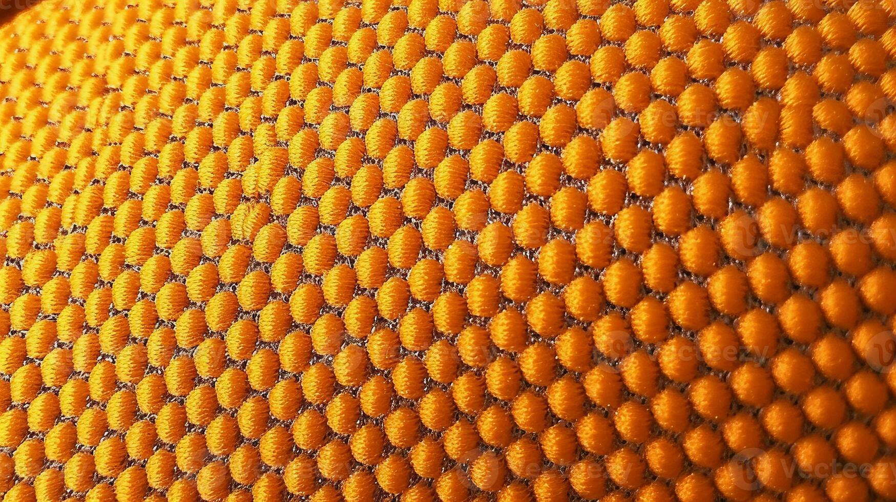 Orange soccer fabric texture with air mesh. Athletic wear backdrop photo