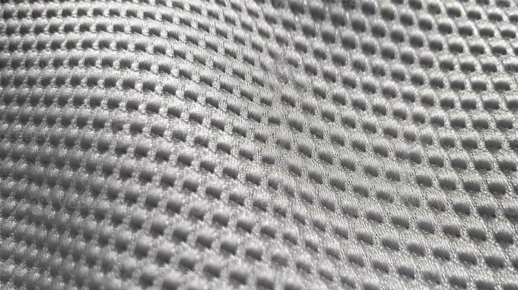Grey soccer fabric texture with air mesh. Sportswear background photo