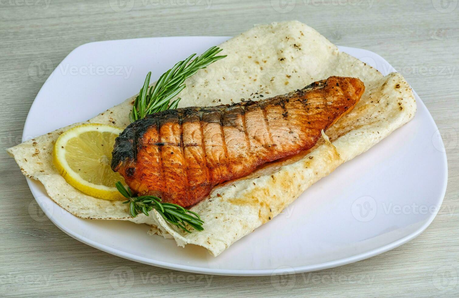 Grilled salmon over wooden photo