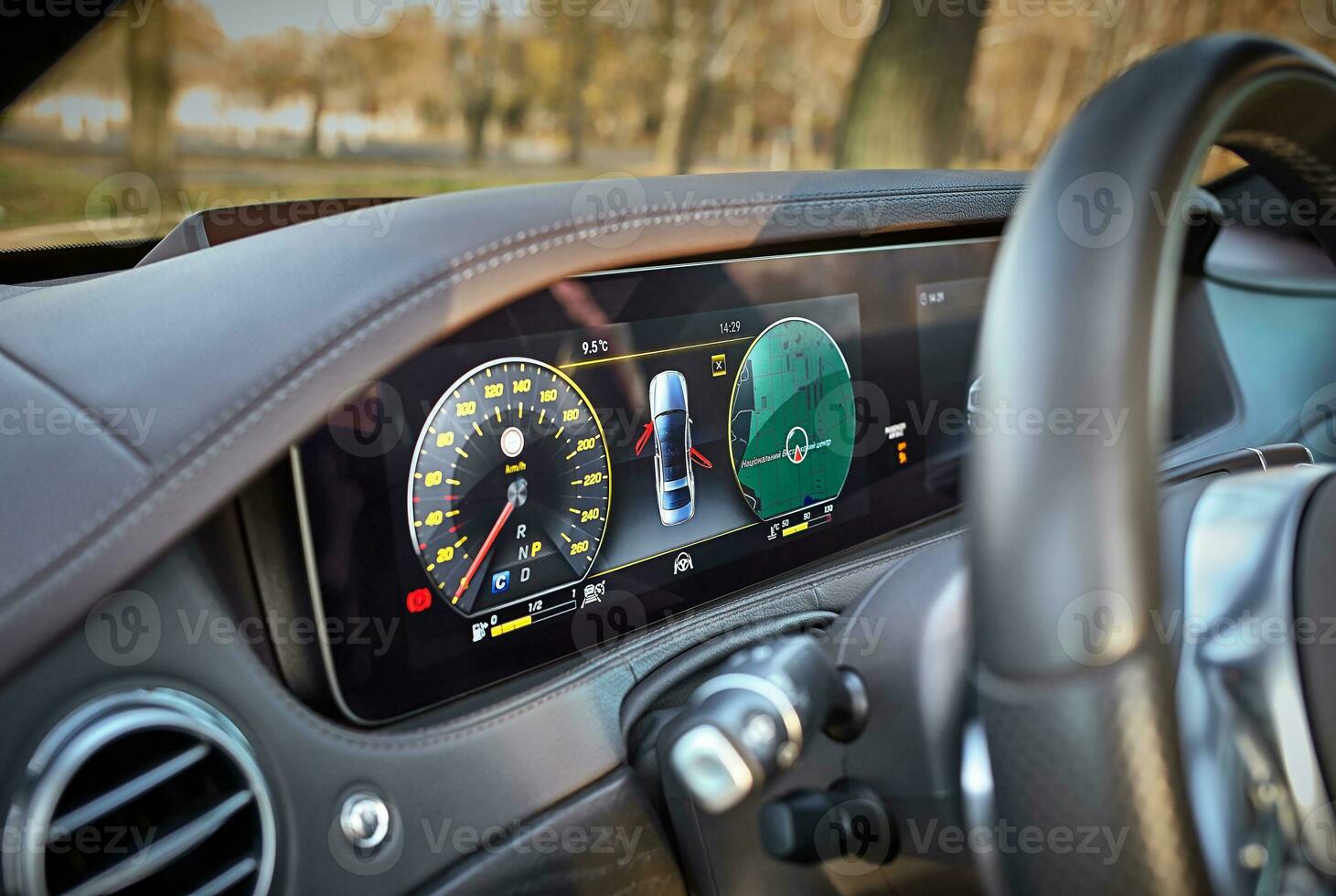 Car steering wheel with car dashboard computer and interior background, modern city car elements close view. Car inside interior photo