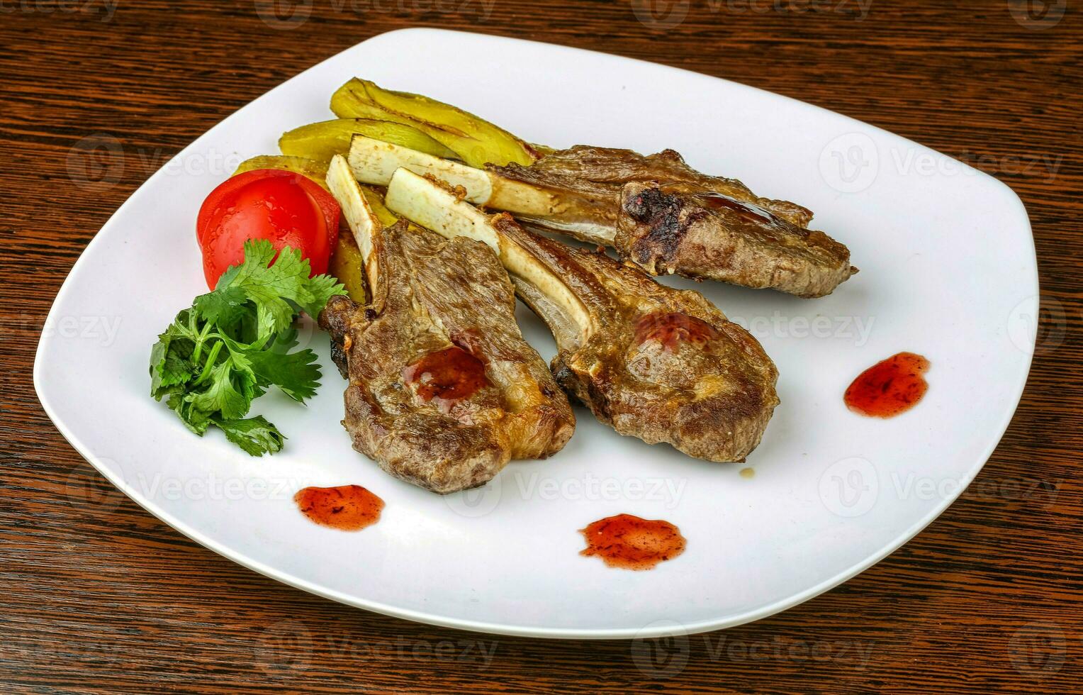 Lamb chops over wooden photo