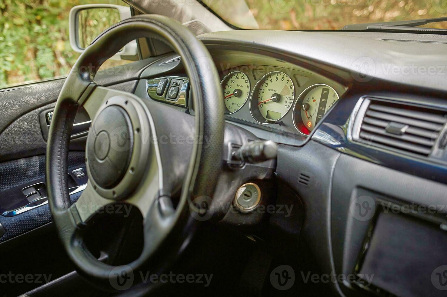 Car steering wheel and car sensors, inerior background, modern city car elements close view. Car inside interior photo