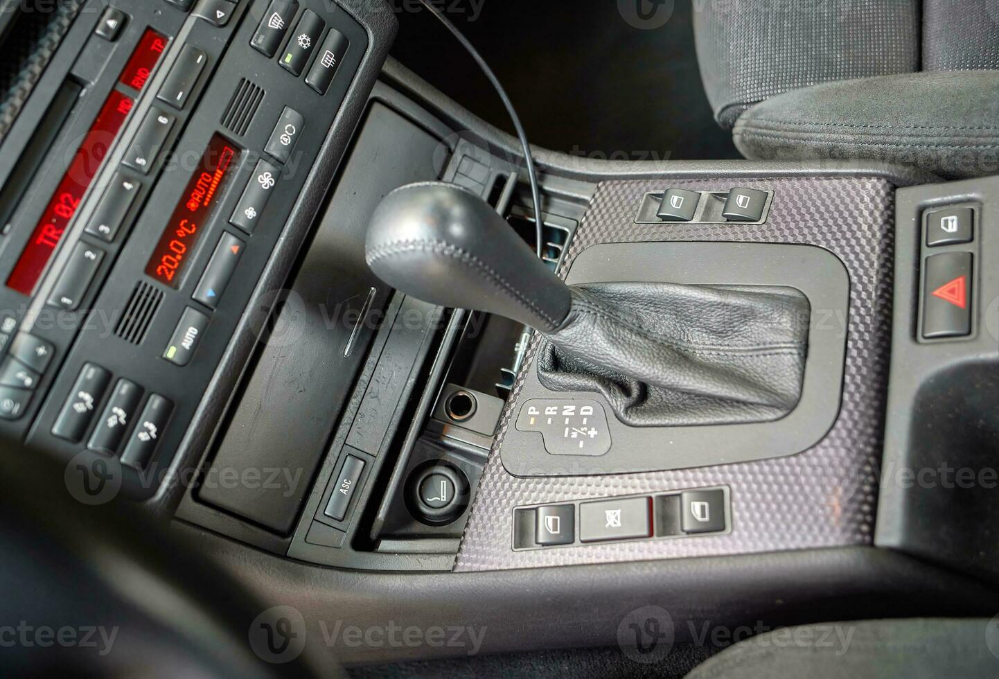 Shift lever, car steering wheel and sensors. Inside a modern car view, city car interior background photo