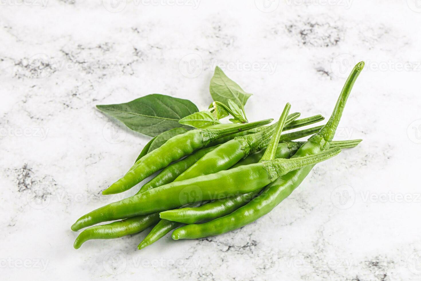 Spicy green chili pepper heap 34063587 Stock Photo at Vecteezy