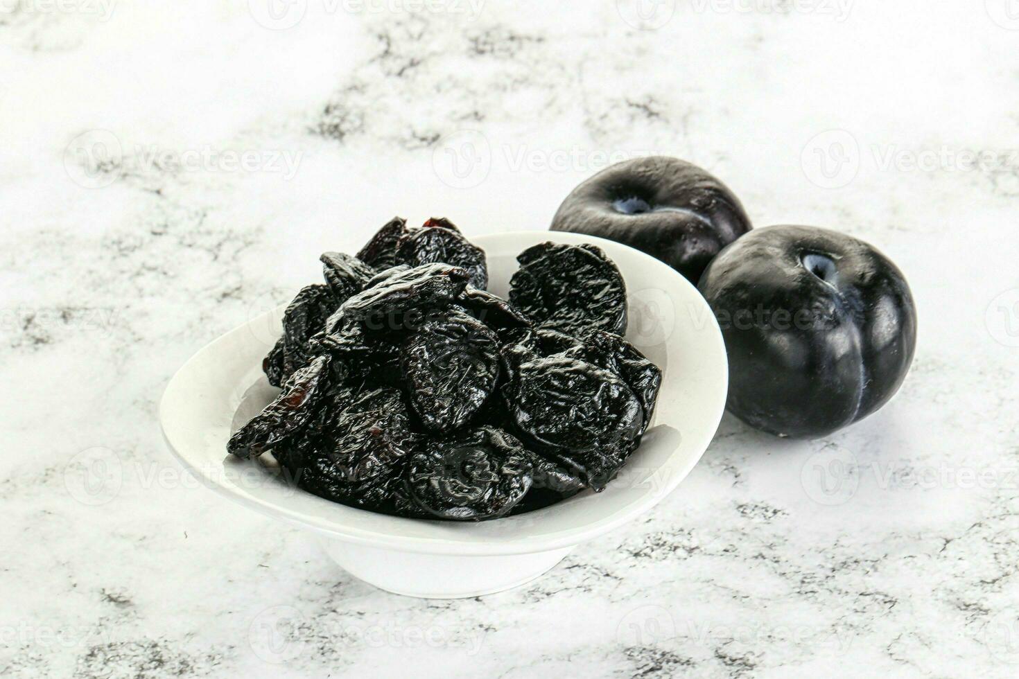 Dry prunes in thw bowl photo