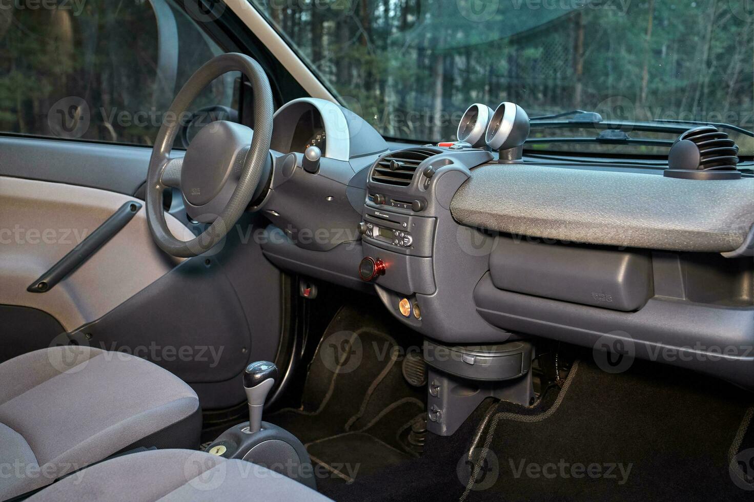 Shift lever, car steering wheel and sensors. Inside a modern car view, city car interior background photo