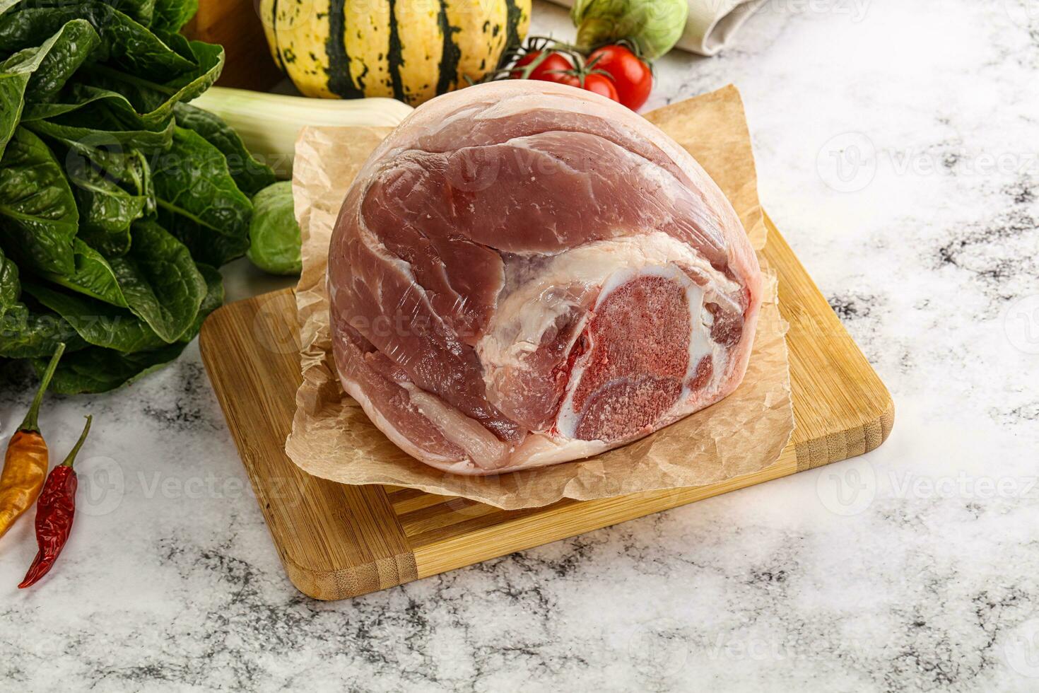 Uncooked raw pork knuckle with spices photo