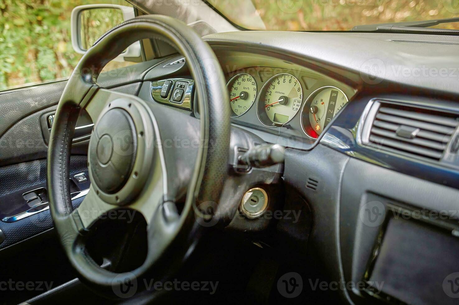 Car steering wheel and car sensors, inerior background, modern city car elements close view. Car inside interior photo