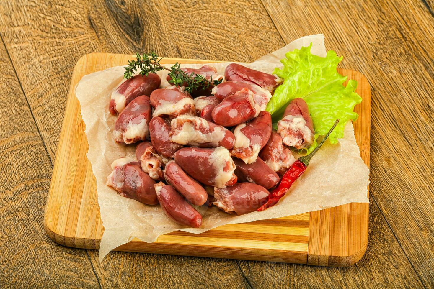 Raw chicken hearts photo