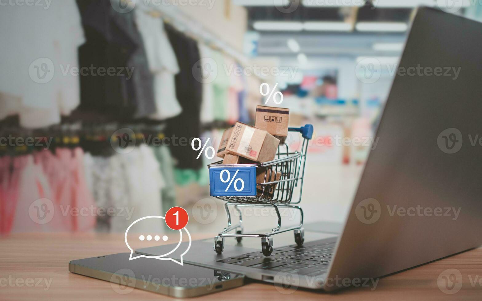 Sale percentage with shopping cart and boxes placed on computer keyboard. Online shopping concept, special price products, Special offers and promotions photo