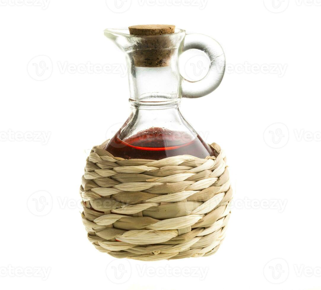 Small decanter with red wine vinegar isolated on the white photo