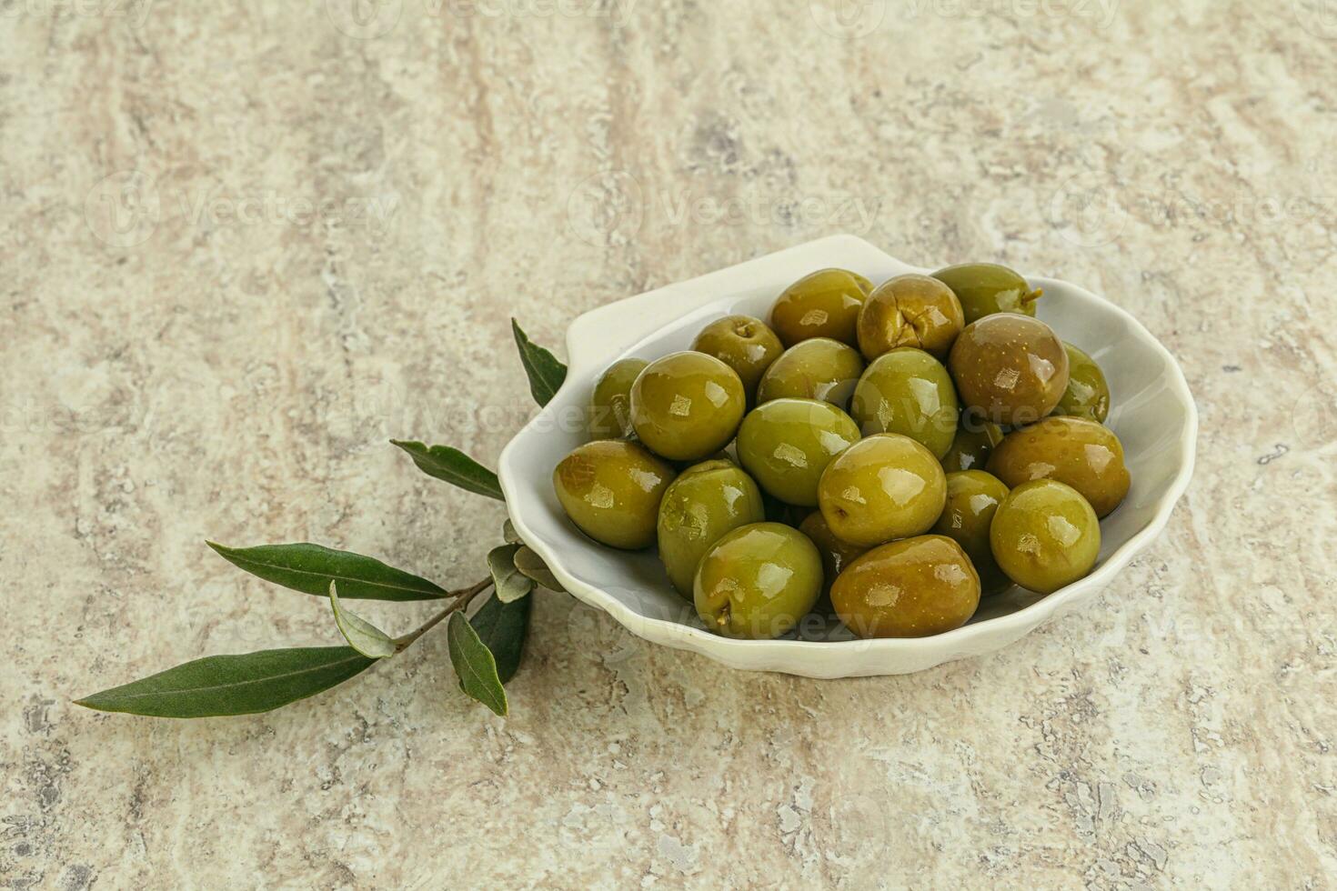 Tasty marinated olives in the bowl photo