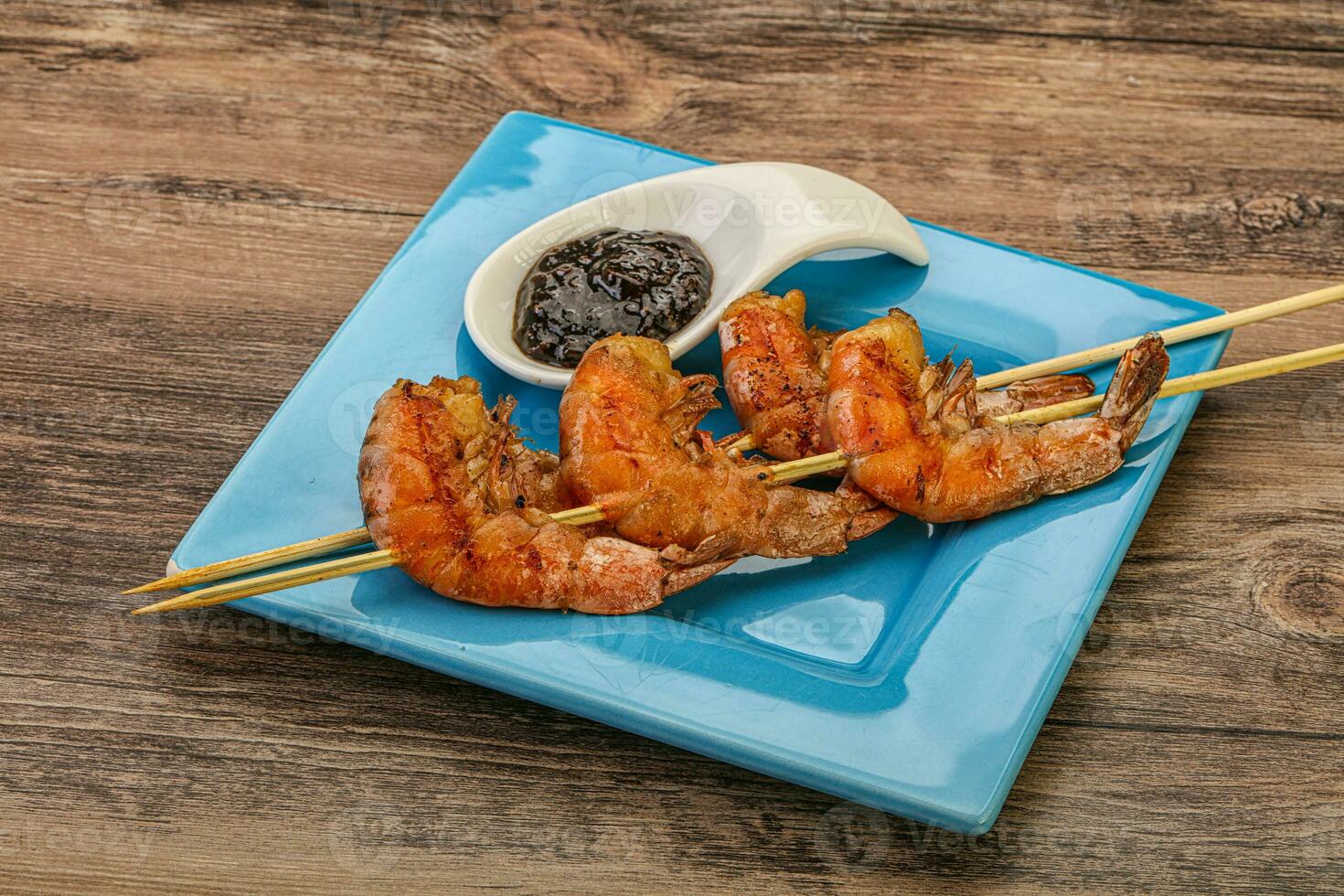 Grilled prawn skewer with pepper sauce photo
